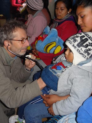 Pediatrician Barry Finette examines a child in Cusco, Peru.