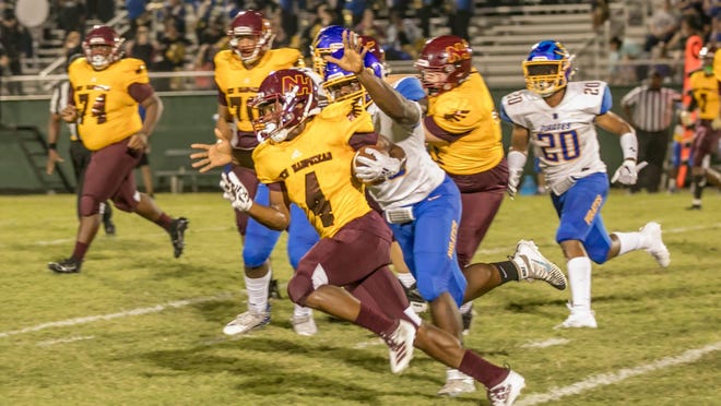 New Hampstead running back Aljhanod "Noddy" Thomas evades the grasp of the Brunswick High defense in a game at Pooler Stadium last year.