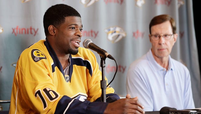 Nashville Predators defenseman P.K. Subban, left, speaks at a news conference Monday in Nashville, Tenn. Subban was acquired from the Montreal Canadiens in a trade for defenseman Shea Weber in June. Predators general manager David Poile, right, looks on.