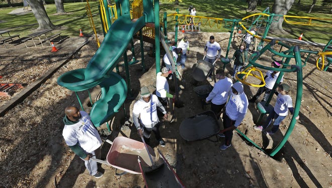 Volunteers, including Green Bay Packers players, Village of Pulaski employees and Brown County United Way employees collaborate in a playground build Tuesday, October 27, 2015, at Shippy Park in Pulaski, Wis. The build is part of the 2015 NFL/United Way Hometown Huddle.
Dan Powers/Post-Crescent Media