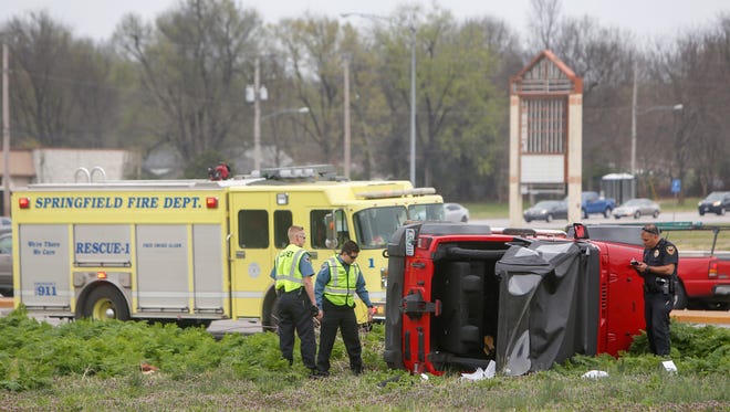 Springfield police officers investigate a one vehicle roll-over accident on Kansas Expressway just south of Grand Street on Tuesday, March 21, 2017. An officer at the scene stated the accident involved non-life threatening injuries.