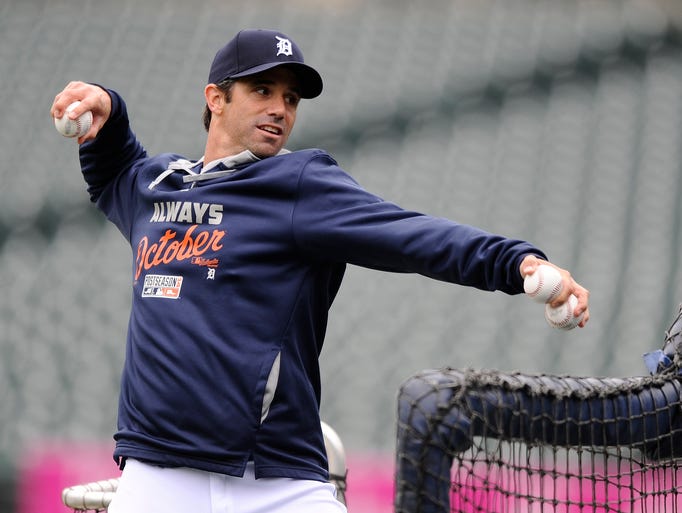 Tigers' manager Brad Ausmus throws pitches during Saturday's batting practice.