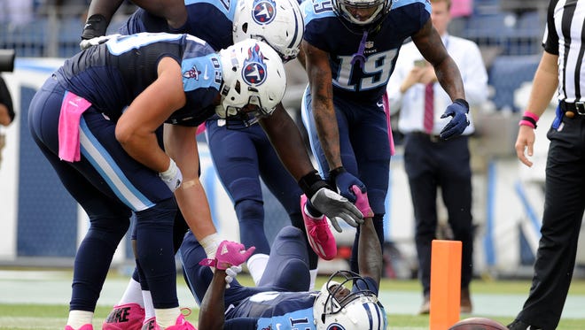Titans tight end Phillip Supernaw (89)], guard Quinton Spain and wide receiver Tajae Sharpe (19) congratulate Titans wide receiver Kendall Wright (13) in the end zone after Wright scored the team's second TD against the Browns on Sunday.