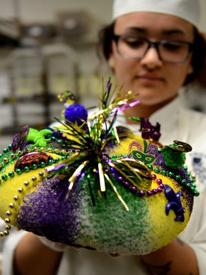 Danielle Drouillard decorates King Cakes at Alpha Delights European Bakery and Cafe in De Pere.