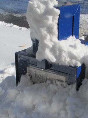 It can get bad! Snow covers an Item newspaper box during a past blizzard.