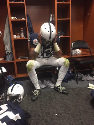 Penn State cornerback Jordan Smith takes a moment in the locker room after the Nittany Lions' 52-49 loss to USC in the Rose Bowl on Jan. 2, 2016.