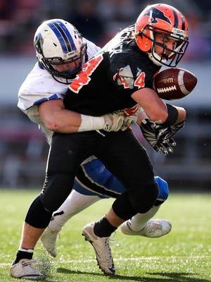 Iola-Scandinavia High SchoolÕs Bryce Huettner is tackled for a fumble by Saint MaryÕs Springs AcademyÕs Clay Schueffner during their WIAA division 6 state championship game Thursday, Nov. 16, 2017, at Camp Randall Stadium in Madison, Wis.