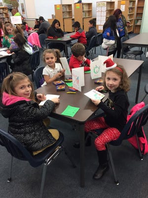 The children enjoyed decorating Christmas cards for soldiers during Milanesi School PTO’s Holiday Family Event.