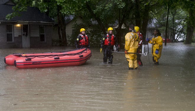 A rescue crew from Indianapolis Fire Department on July 7, 2015, surveys heavy flooding.