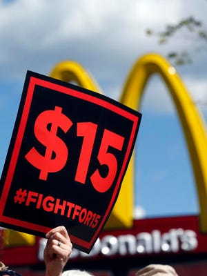 FILE - In this July 22, 2015 file photo, supporters of a $15 minimum wage for fast food workers rally in front of a McDonald's in Albany, N.Y. Millions of workers across the U.S. will see their pay increase as 19 states bump up their minimum wages as the new year begins. California, New York and Arizona are among the states with increases taking effect Saturday, Dec. 31, 2016 or Sunday, Jan. 1, 2017. New York state is taking a regional approach, with the wage rising to $11 in New York City, $10 in its suburbs and $9.70 upstate.