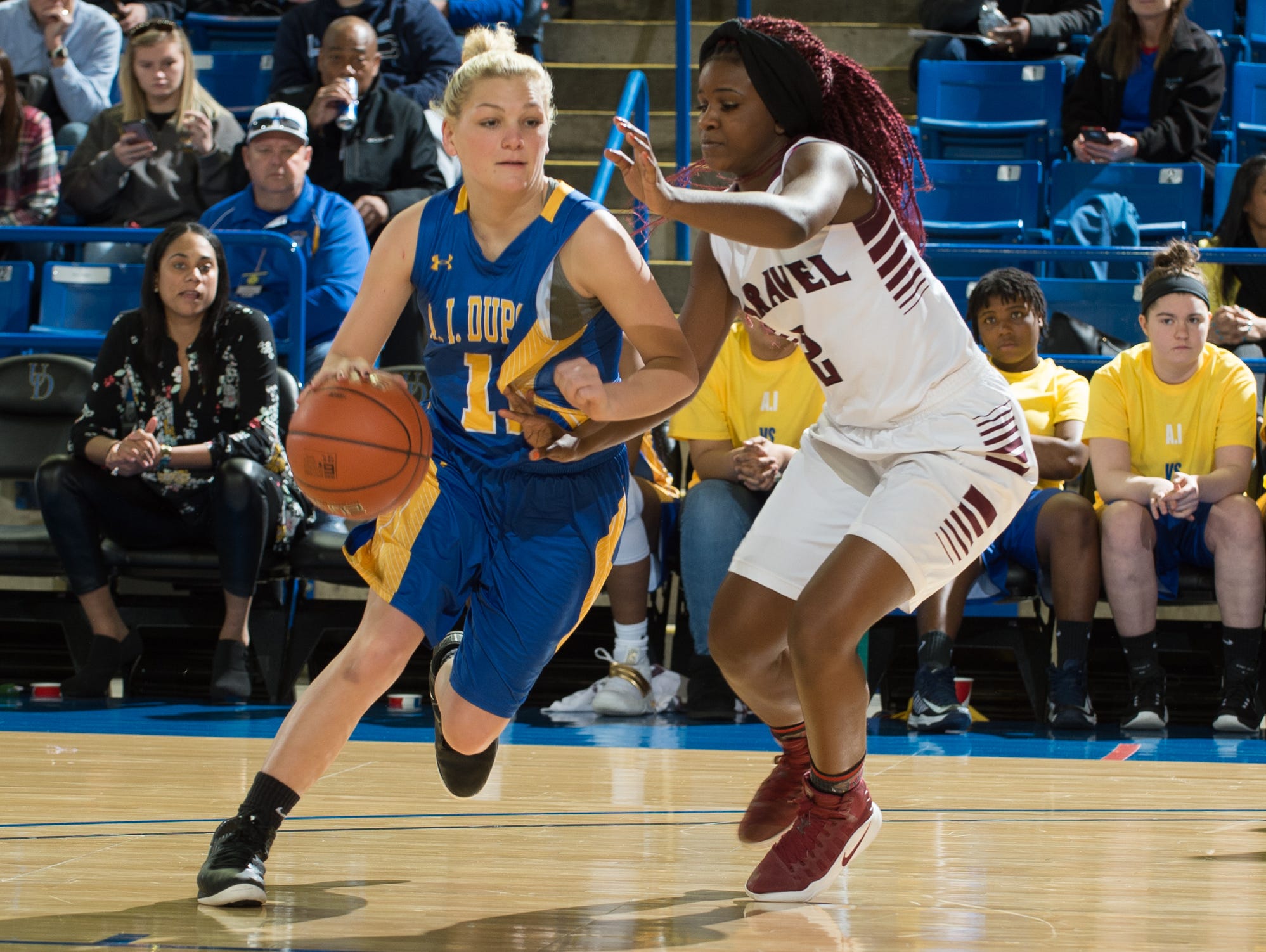 Caravel's Maia Bryson (right) defends against A.I. du Pont’s Sydney MacDonald in the quarterfinals of the DIAA Girls Basketball Tournament last Saturday.