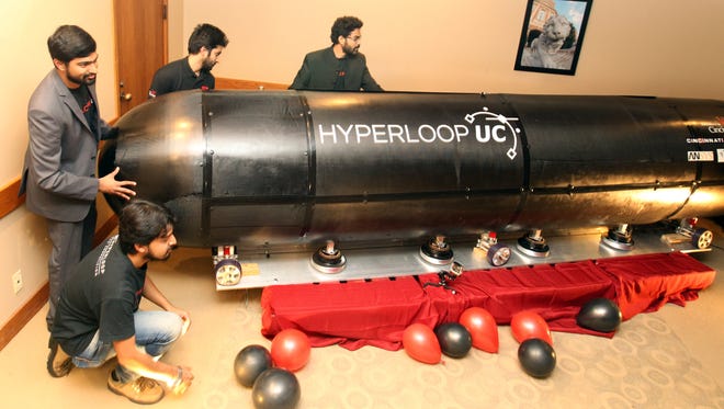 Members of the Hyperloop UC team (left to right) Sid Sridhar, Abishek Soni, Kanishk Tyagi and Gaurang Gupta admire a transportation pod they created that is designed to travel within a tube at 750 mph, just shy of the speed of sound (768 mph).