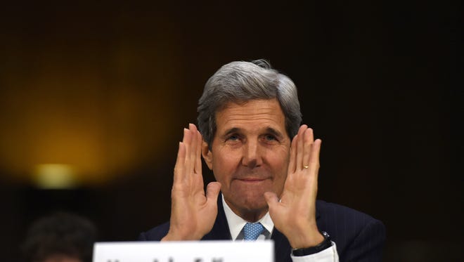 Secretary of State John Kerry greets committee members as he arrives on Capitol Hill in Washington, Tuesday, Dec. 9, 2014, to testify before the Senate Foreign Relations hearing on "Authorization for the Use of Military Force Against IS."  (AP Photo/Molly Riley)