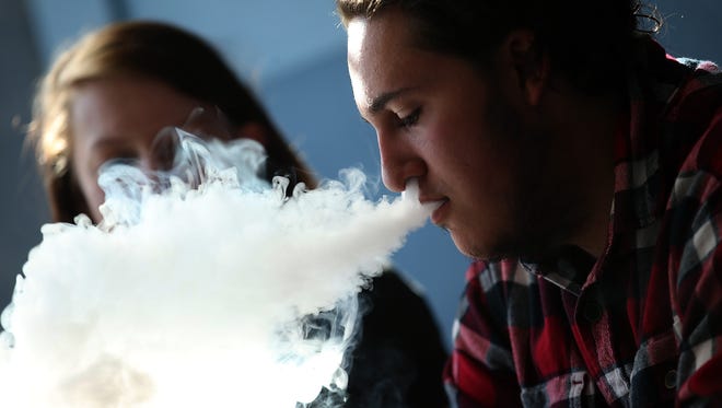Kieran Thomas smokes an e-cigarette at Digita Ciggz on Jan. 28 in San Rafael, Calif.
