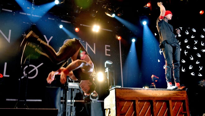 Musicians Josh Dun, left, and Tyler Joseph of twenty one pilots perform onstage at the iHeartRadio Theater LA on May 19, 2015, in Burbank, Calif.