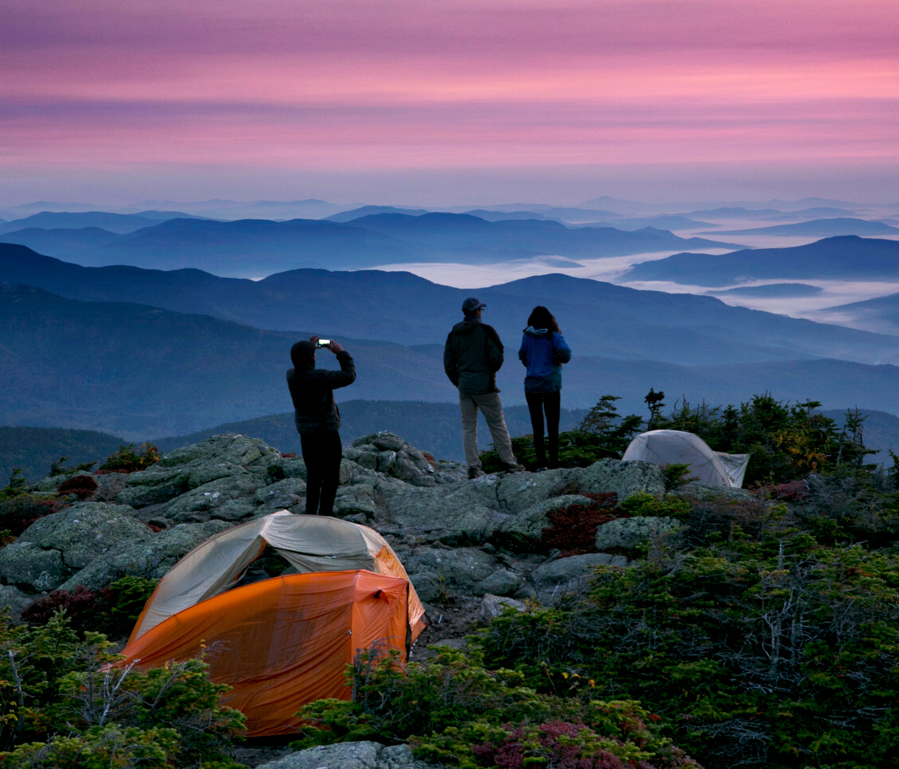 Robert Weiss photographs his brother-in-law, Matthew Ferri, and his wife, Andrea  just before sunrise from their campsite on the Appalachian Trail in Beans Purchase, N.H., Sept. 17, 2017.