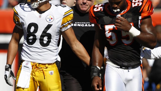 Bengals linebacker Keith Rivers gets a pat on the rear by the Steelers' Hines Ward after his hit put Rivers out of the game with an injured jaw.
