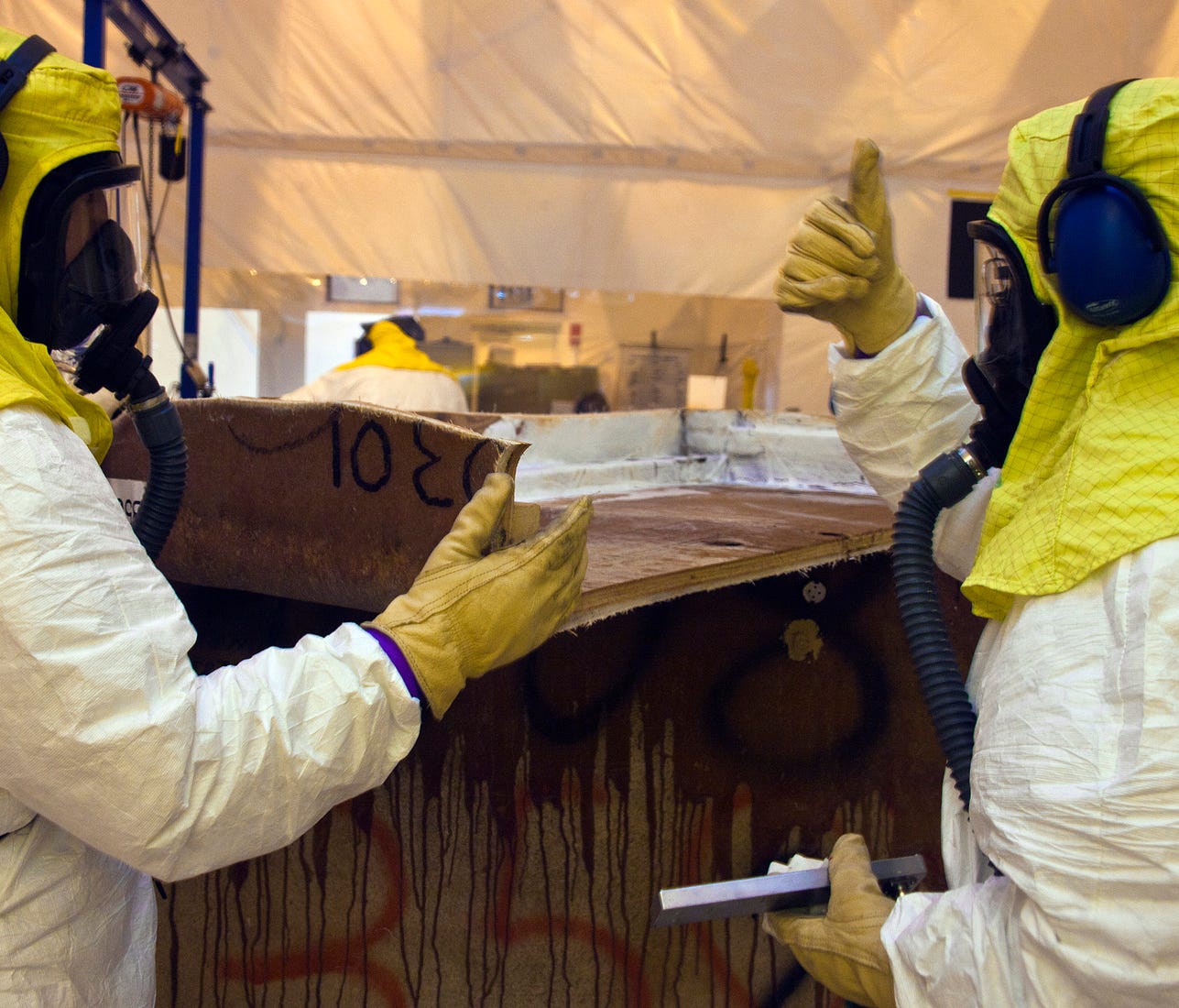 Crews repackage waste from a fiberglass reinforced plywood box into a container that can be shipped to the Waste Isolation Pilot Plant near Carlsbad, N.M.