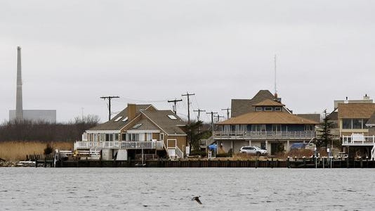 This 2010 photo shows homes along Barnegat Bay in Lacey with the Oyster Creek nuclear plant in the background.