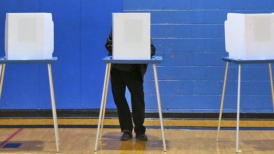 A voter casts his ballot at the Douglass Park Community Center on Election Day in November 2014.