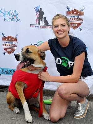 Kate Upton, whose fiance Justin Verlander pitches for the Tigers, is a good friend to the dog community as shown at a dog adoption event during spring training in Florida. The Tigers will host "Bark at the Park" June 21 at Comerica.