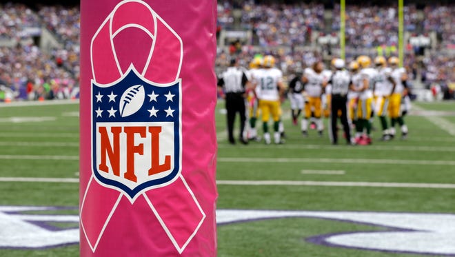 A Breast Cancer Awareness Month logo is wrapped around the goal post during the first half of a NFL football game last season between the Baltimore Ravens and the Green Bay Packers. The NFL's annual breast cancer awareness campaign will be on full display again in October.