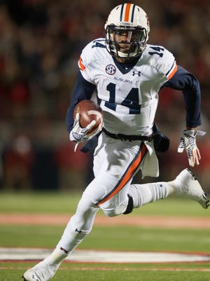 Auburn quarterback Nick Marshall (14) runs downfield during the NCAA football game at University of Mississippi in Oxford, Miss., on Saturday, Nov. 1, 2014. Auburn defeated Mississippi 35-31