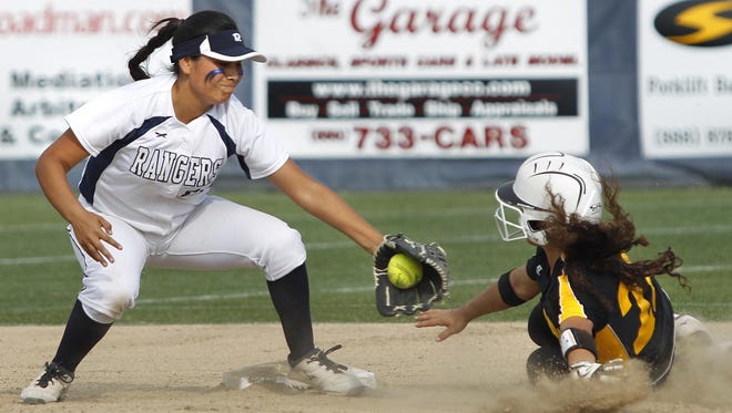 Golden West’s Amanda Ojeda, right, slides under Redwood’s Makailah Hernandez’s tag in a West Yosemite League softball game Thursday in Visalia.