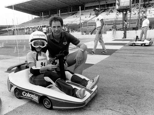 NASCAR driver Darrell Waltrip, right, gives tips to