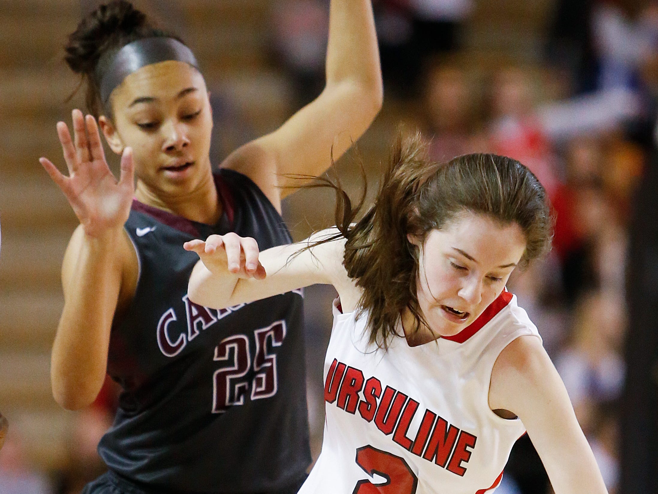 Caravel's Terea Hunt (left) can't stop Ursuline's Maggie Connolly from grabbing a loose ball in the first half of the Raiders' 54-32 win in the DIAA state tournament title game at the Bob Carpenter Center Friday.