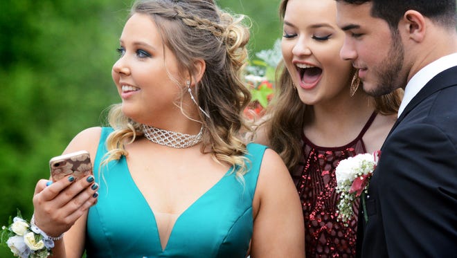 From left, Kaylee Mustard, Tess Murphy and Joey DePasquale looks at photos at the York Country Day School Prom at the Country Club of York Wednesday, June 6, 2018. Bill Kalina photo