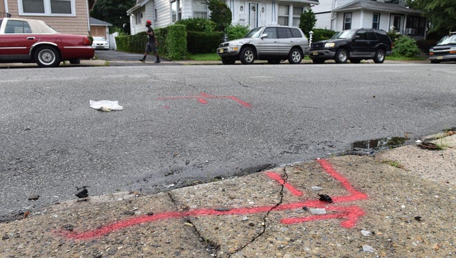A food delivery man was shot on 34th Street in Paterson on Thursday in the early morning hours July 26, 2018. Red paint marks where the car he was driving came to a stop after crashing.