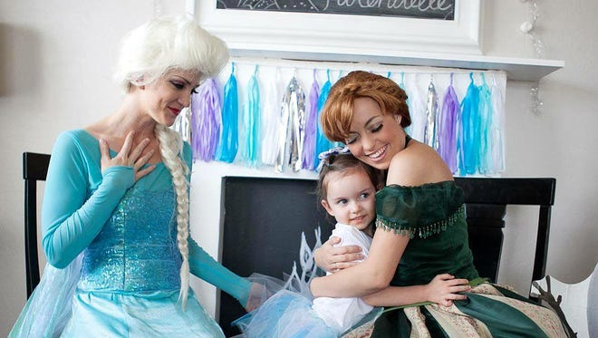 Two actresses from Fairytale Events dress up as princesses who look like Anna and Elsa from the Disney movie "Frozen."