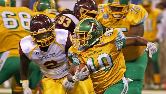 Kentucky State University's #40 Adrian Williams-Ralston gets pressure from Central State University's #2 Deonate Gary as he looks for an opening during the Circle City Classic XXXII game between Central State University and Kentucky State University at Lucas Oil Stadium, Saturday, September 26, 2015.  Kentucky State University won 21-17.
