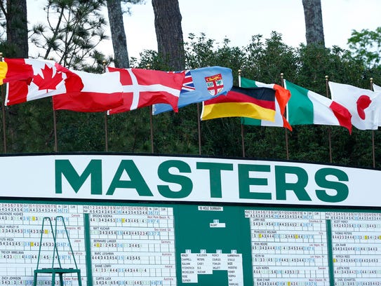 Flags fly in the wind atop the main leaderboard during