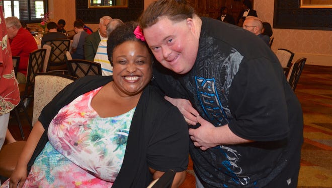 Meals on Wheels volunteer and resident of Our House, Ryan Daudt (right), with vocalist Rhonda Denet, of Jersey City, who provided entertainment for the SAGE Eldercare annual volunteer luncheon July 25.