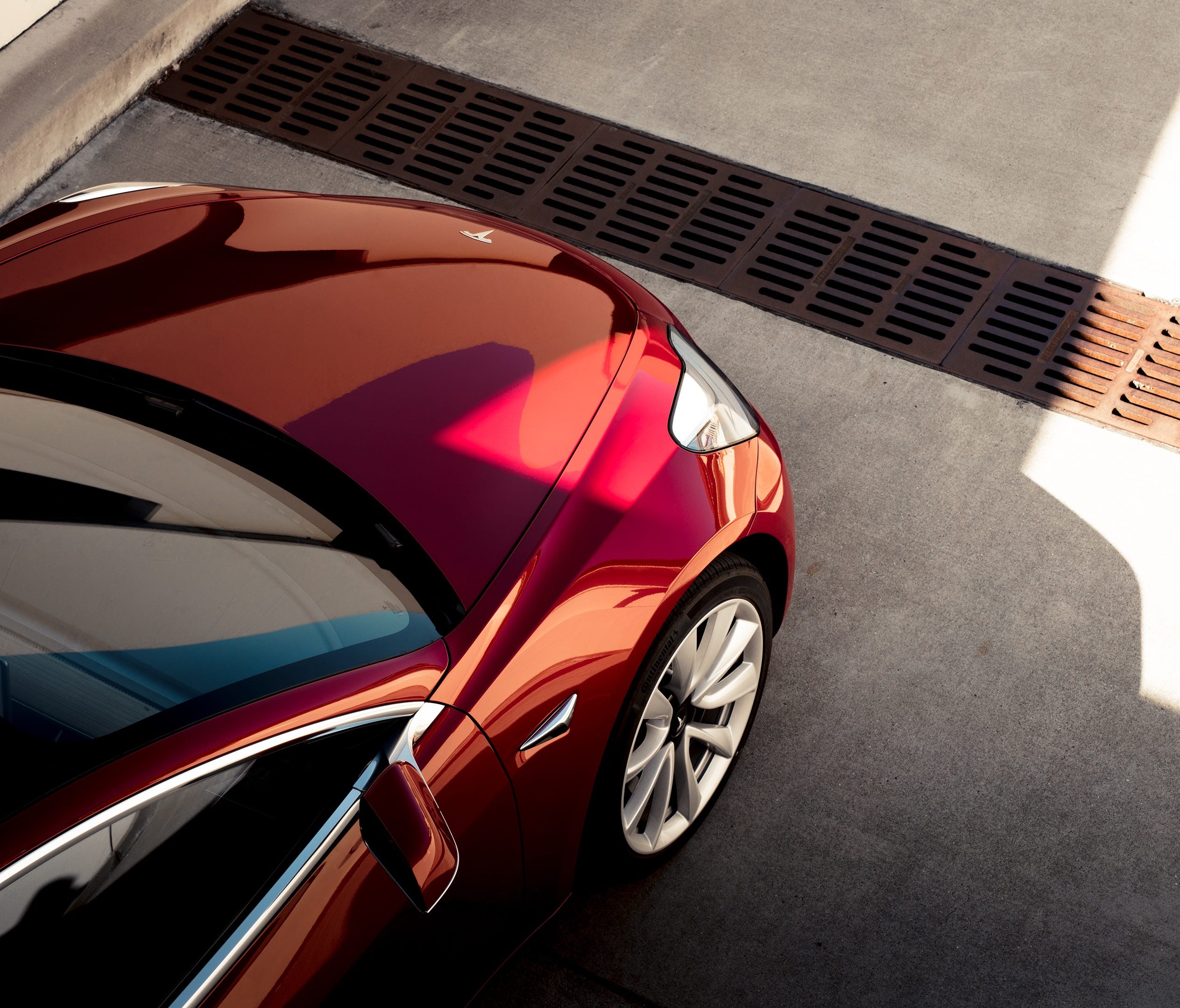 The Tesla Model 3 takes many of its stylistic cues from its larger sibling, the Model S sedan.