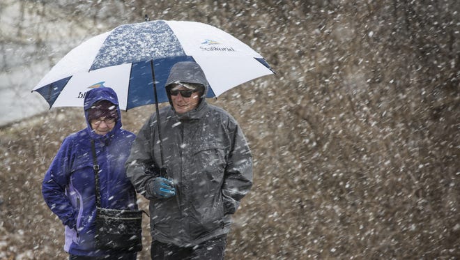 Sophie and Ervin Hegedus of Fort Wright were caught in the snow on their walk in Devou Park Monday afternoon.