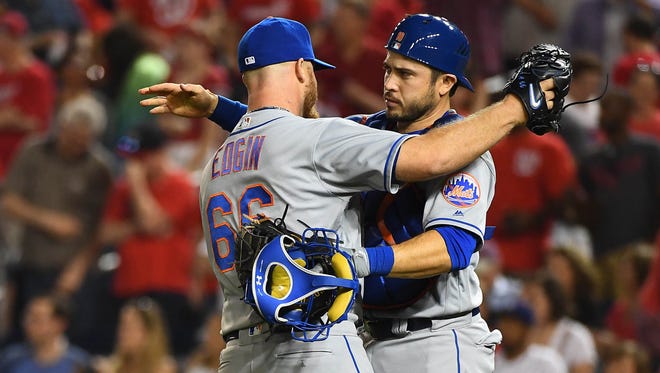 Mets relief pitcher Josh Edgin (66) is congratulated by catcher Travis d'Arnaud (18) after earning a save against the Washington Nationals at Nationals Park on Friday night.