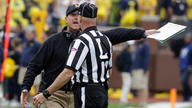 Michigan head coach Jim Harbaugh argues a penalty call against the Wolverines during 4th action between  Michigan and Oregon State on Saturday, Sept. 12, 2015 in Ann Arbor.