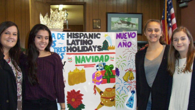 Members of the Houston County High School Hispanic Honor Society were recently invited to the J. D. Lewis Senior Citizens Center to share with seniors how different Latino and Hispanic cultures celebrate Christmas, New Years and Three Kings Day.  From left is Crysta Darr, Spanish teacher; Nayeli Garcia; Jonea Davis; and Lauren Stephens.