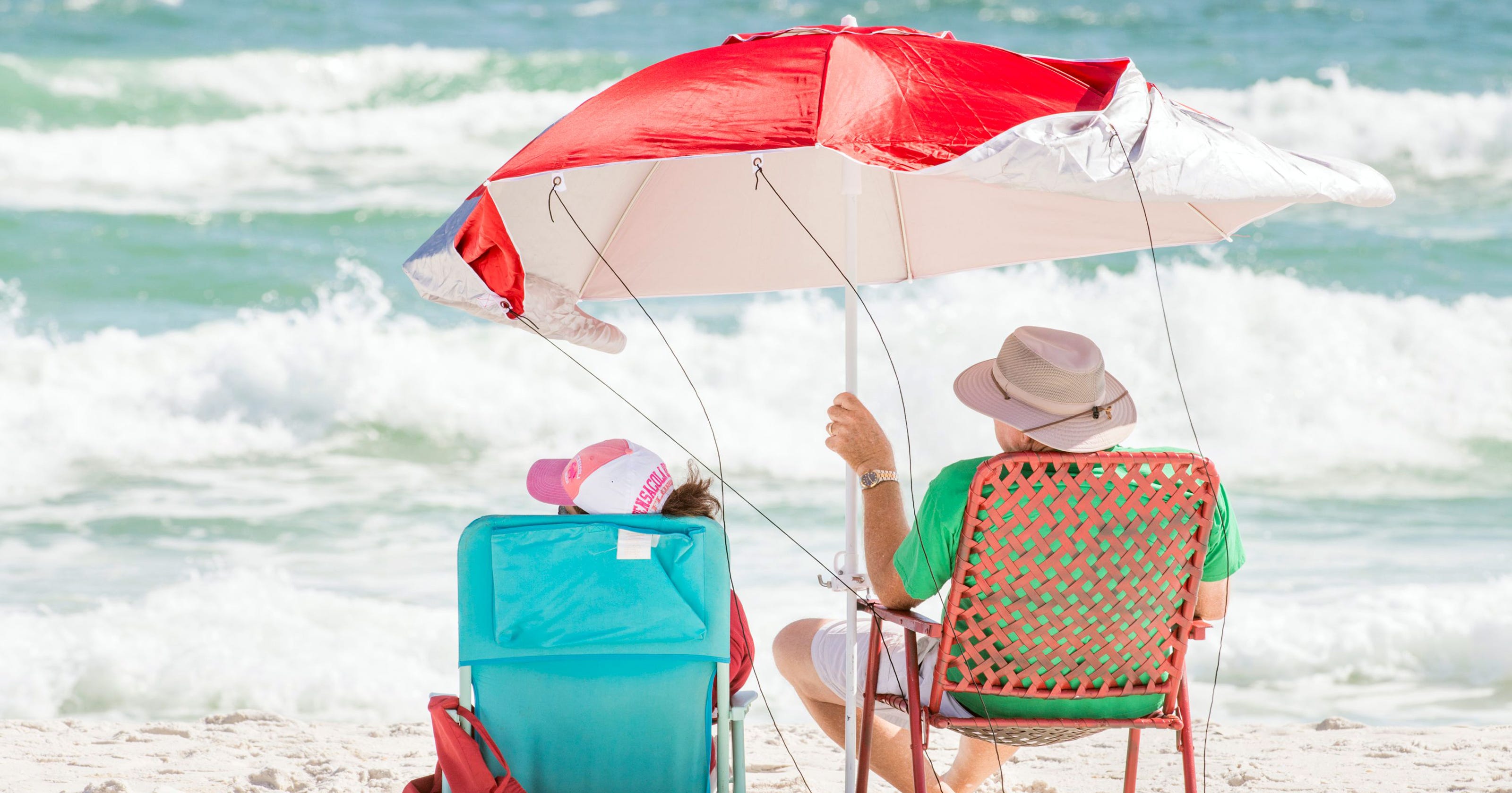 Wind Gust Drives Point Of Beach Umbrella Through Brit