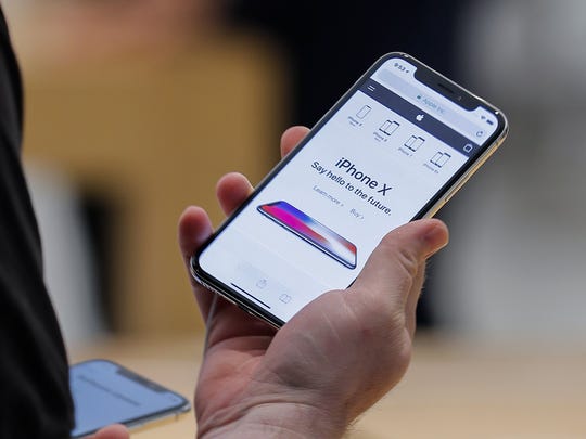 A customer examines the newly released iPhone X at