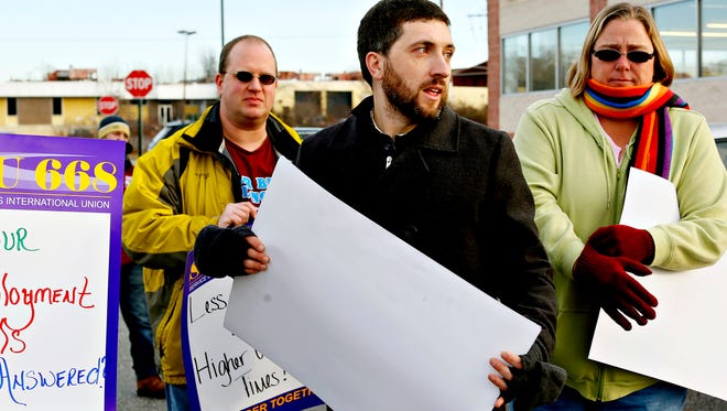 SEIU Local 668 Business Agent Stephen Catanese, center, directs recently furloughed state workers James Jensen, left, and Amy Jensen, right, both of Windsor Borough, as he leads the group in protest prior to State Senator Wagner's announcement of  his intentions to run for governor in 2018 during a press conference at Penn Waste in East Manchester Township, Wednesday, Jan. 11, 2017. The Jensens both worked at the Harrisburg Central Office and were a part of the 521 state employees who were furloughed due to a lack of funding. Dawn J. Sagert photo