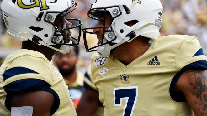 Georgia Tech wide receiver Jalen Camp (1) celebrates his touchdown with Georgia Tech quarterback Lucas Johnson (7) during the second half of an NCAA college football game against the Citadel, Saturday, Sept. 14, 2019, in Atlanta. The Citadel won 27-24 in overtime. (AP Photo/Mike Stewart)
