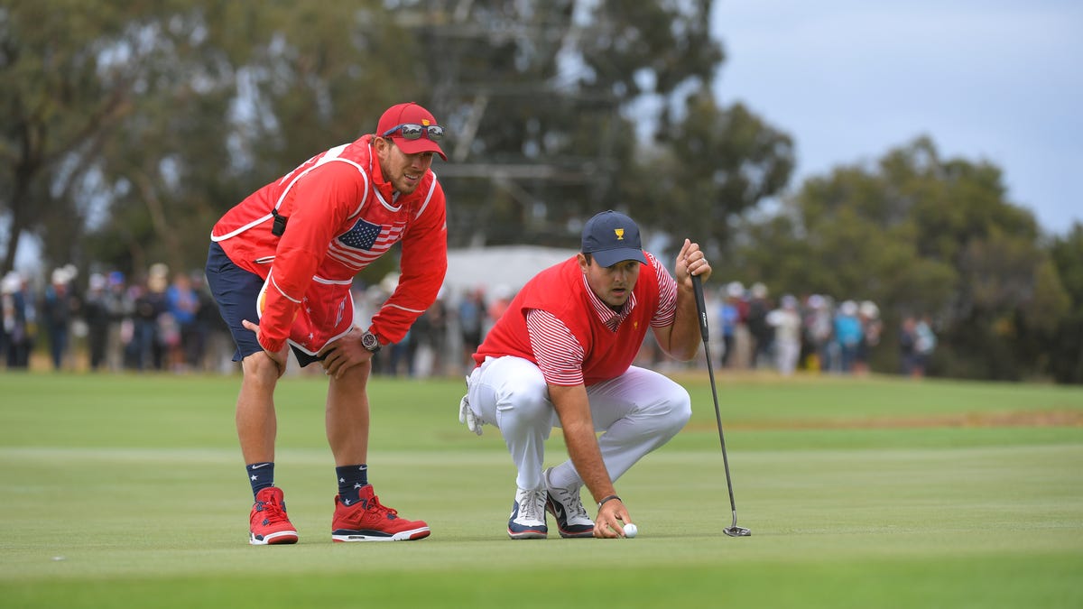 Caddie Kessler Karain and Patrick Reed during the first round four-ball matches of the Presidents Cup at The Royal Melbourne Golf Club on December 12, 2019, in Melbourne, Australia. (Photo by Ben Jared/PGA TOUR via Getty Images)