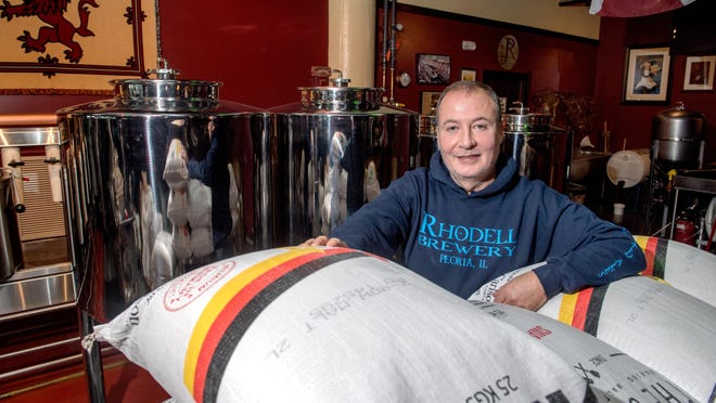 Mark Johnstone, owner of Rhodell Brewery, 100 Walnut Street #111, poses near his tanks and bags of malt at his pub in Peoria's Warehouse District.