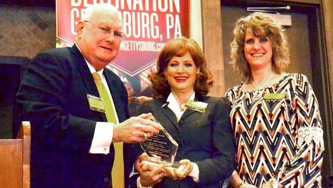 Jacqueline White, center, receives the “Jim Getty Spirit of Gettysburg Award,” from Norris Flowers, president of Destination Gettysburg, left, and Tammy Myers, chairwoman of Destination Gettysburg’s board of directors, right.