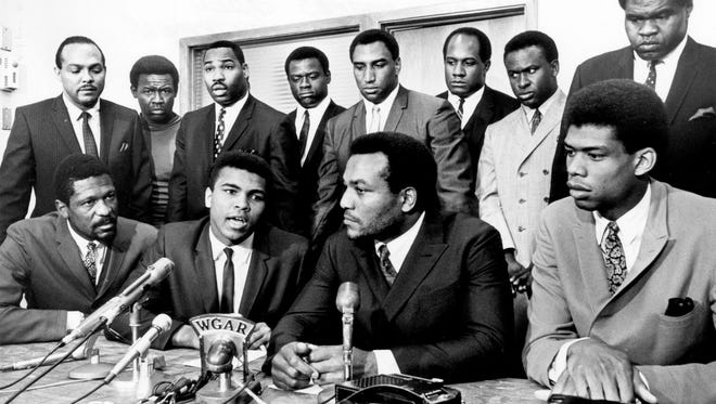 Former Cleveland Browns Hall of Fame running back Jim Brown presides over a meeting of top black athletes who supported boxer Muhammad Ali's refusal to fight in Vietnam on June 4, 1967. Pictured: (front row, from left) Bill Russell, Muhammad Ali, Jim Brown, Lew Alcindor; (back row) Carl Stokes, Walter Beach, Bobby Mitchell, Sid Williams, Curtis McClinton, Willie Davis, Jim Shorter, and John Wooten.