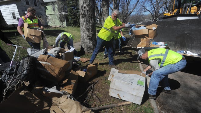 Employees with the city of Sioux Falls clean up along Duluth Avenue in April during Project NICE.